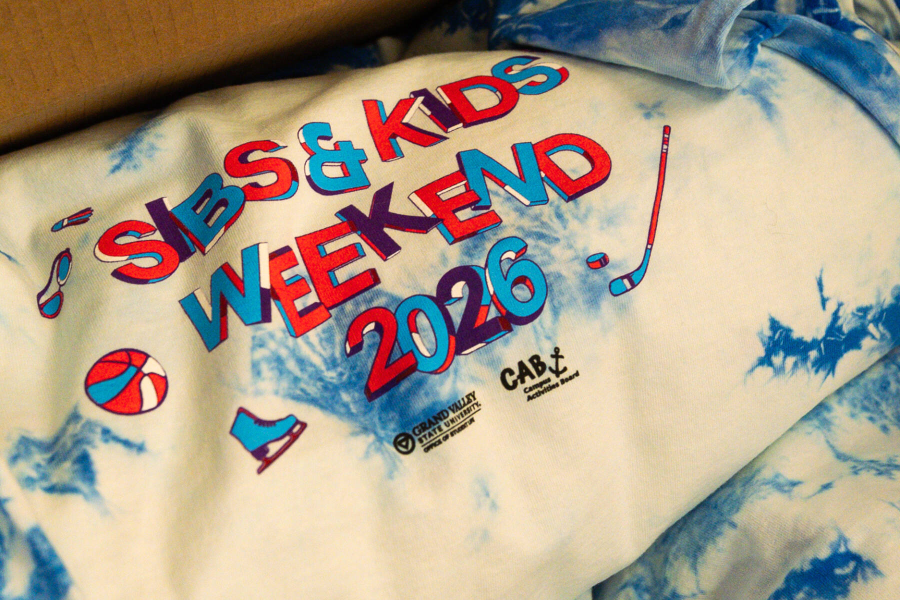 A box of Sibs & Kids Weekend 2026 t-shirts